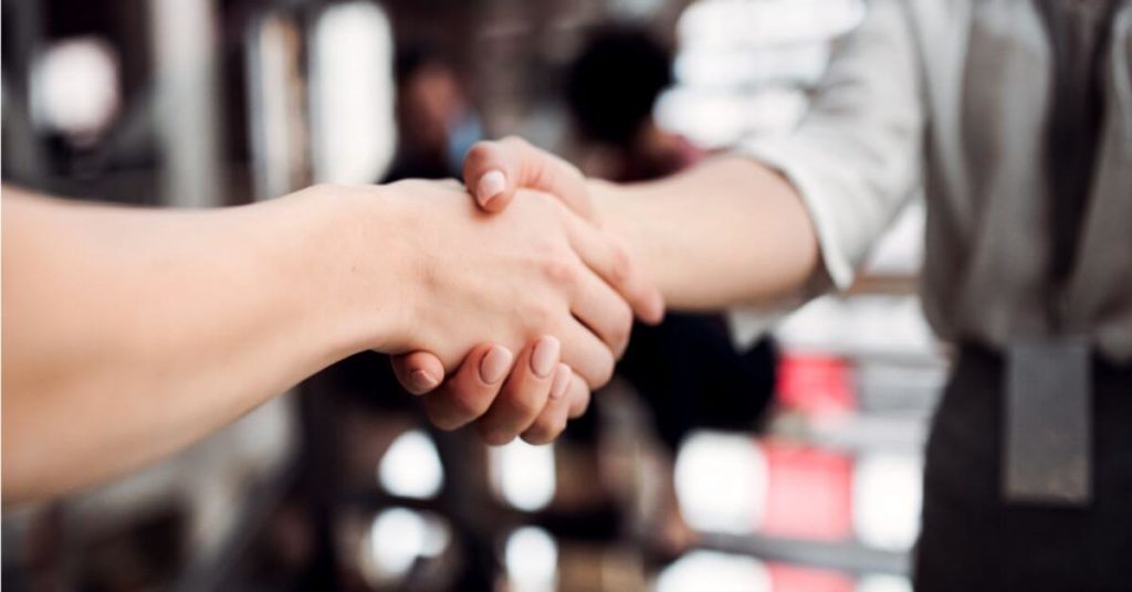Business partners are shaking hands over independent adjuster