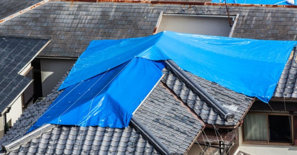 A house with roof damage after insurance settlement has been approved