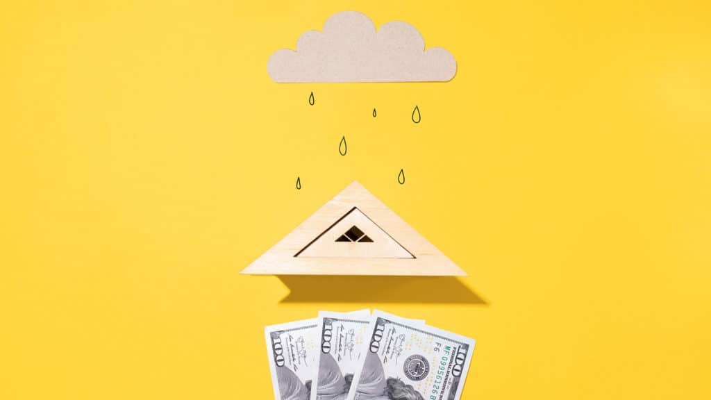 Roof protects money from rain, creative flat lay. Bank concept, protection of finances, saving money in during inflation