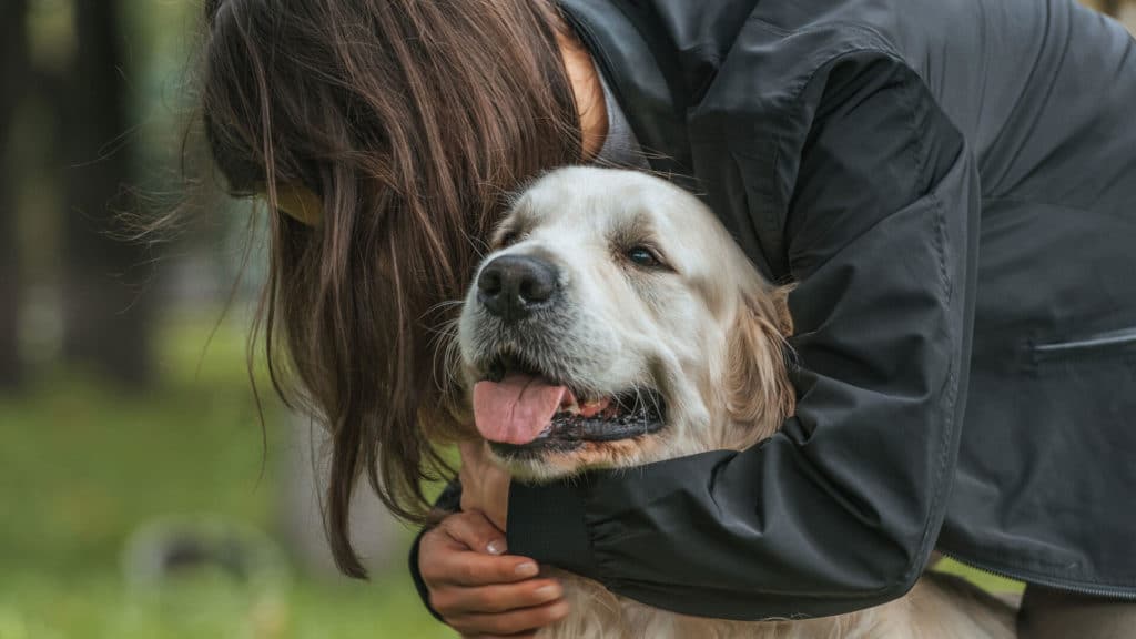 Woman hugging pet dog during a Wildfire Emergency