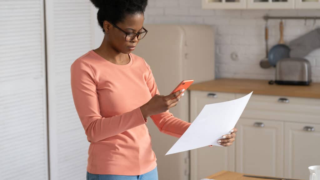 Woman using a phone to share document related to insurance claim