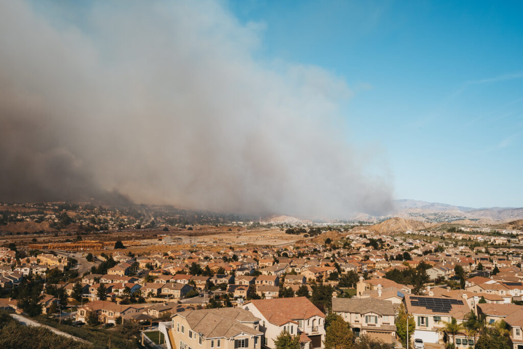 California neighborhood with wildfire smoke in background