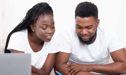 A young black couple are going over a inventory list