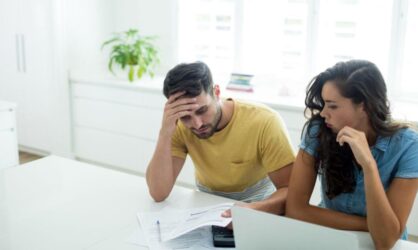 A young couple stressed about their insurance coverage before a public adjuster